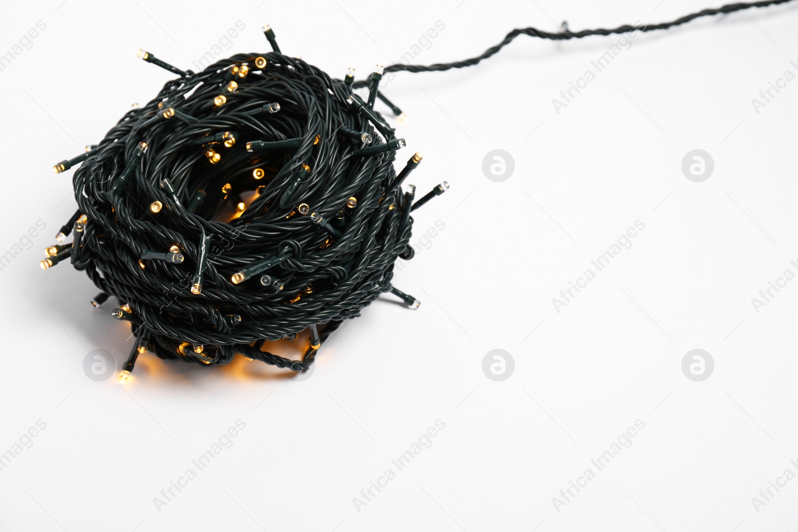 Photo of Bundle of beautiful Christmas lights on white background