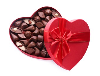 Photo of Heart shaped box with delicious chocolate candies on white background, top view