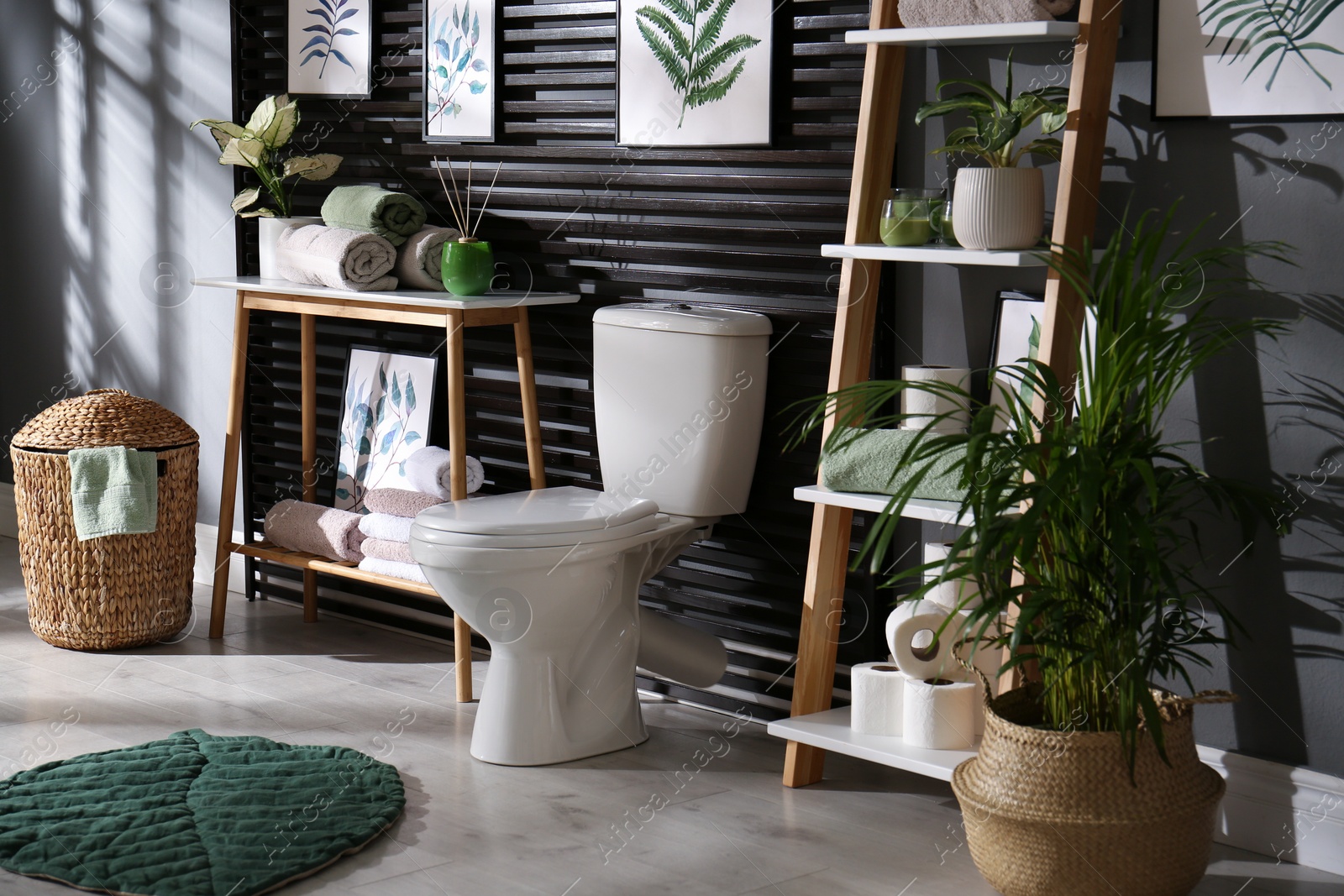 Photo of Stylish bathroom interior with toilet bowl and other essentials