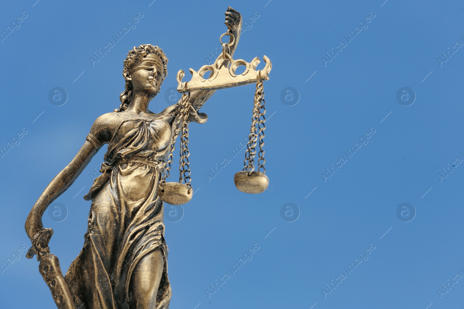 Photo of Symbol of fair treatment under law. Figure of Lady Justice against sky, closeup with space for text