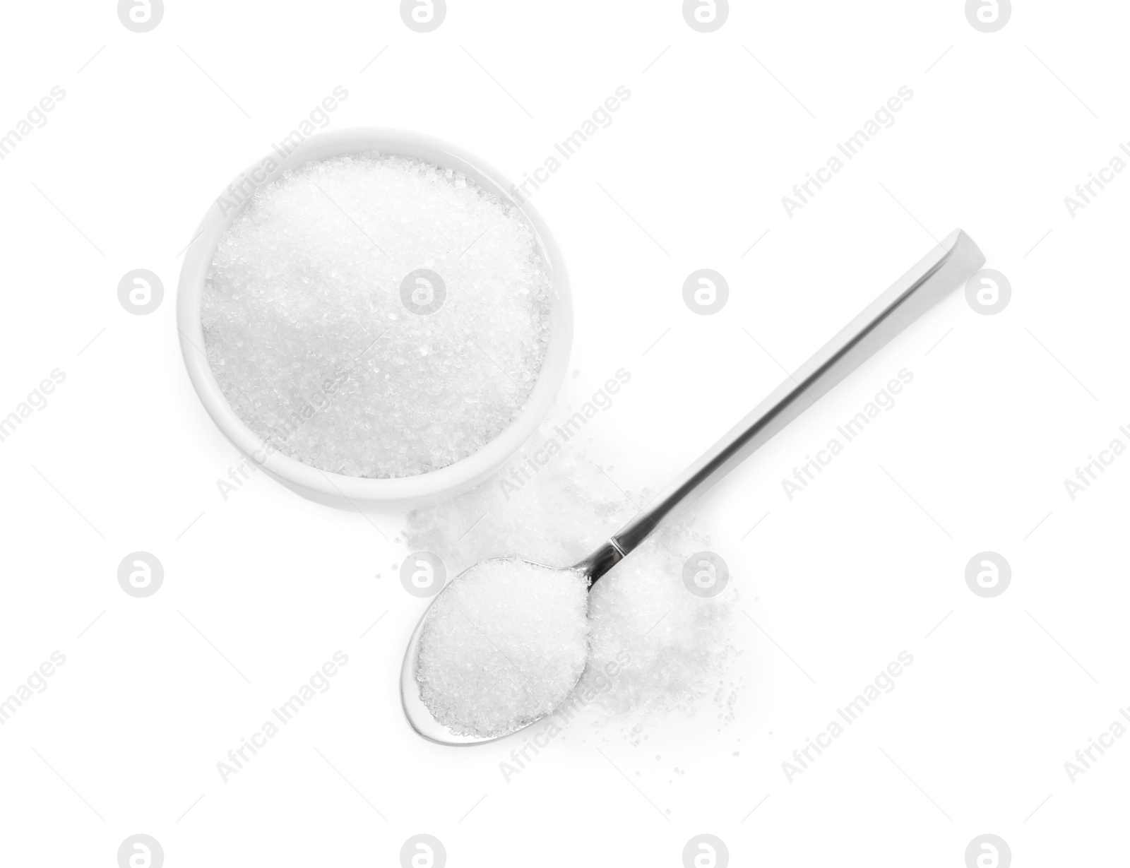 Photo of Bowl and spoon of granulated sugar on white background, top view