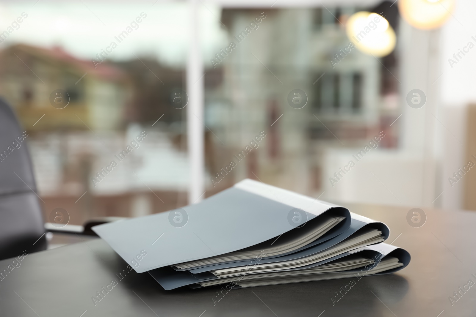 Photo of Stack of folders with documents on office table. Space for text