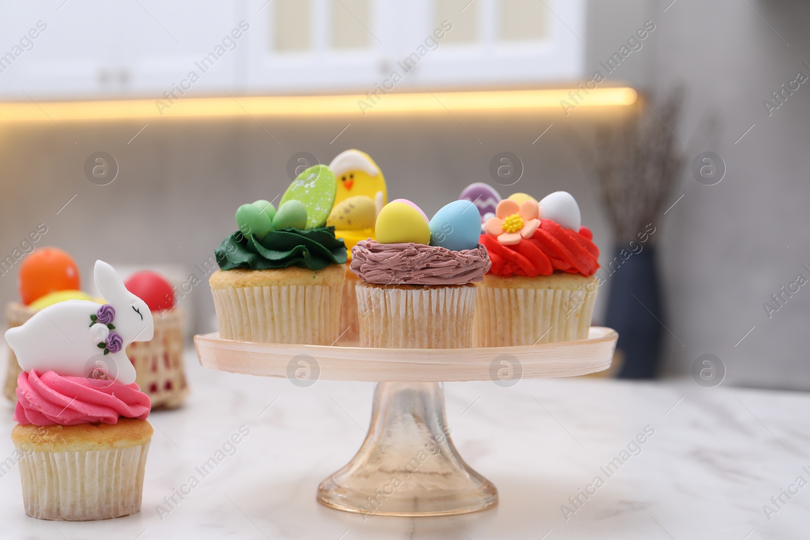 Photo of Tasty decorated Easter cupcakes on white marble table