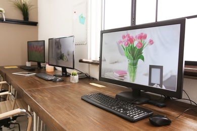 Stylish workplace interior with computers on tables