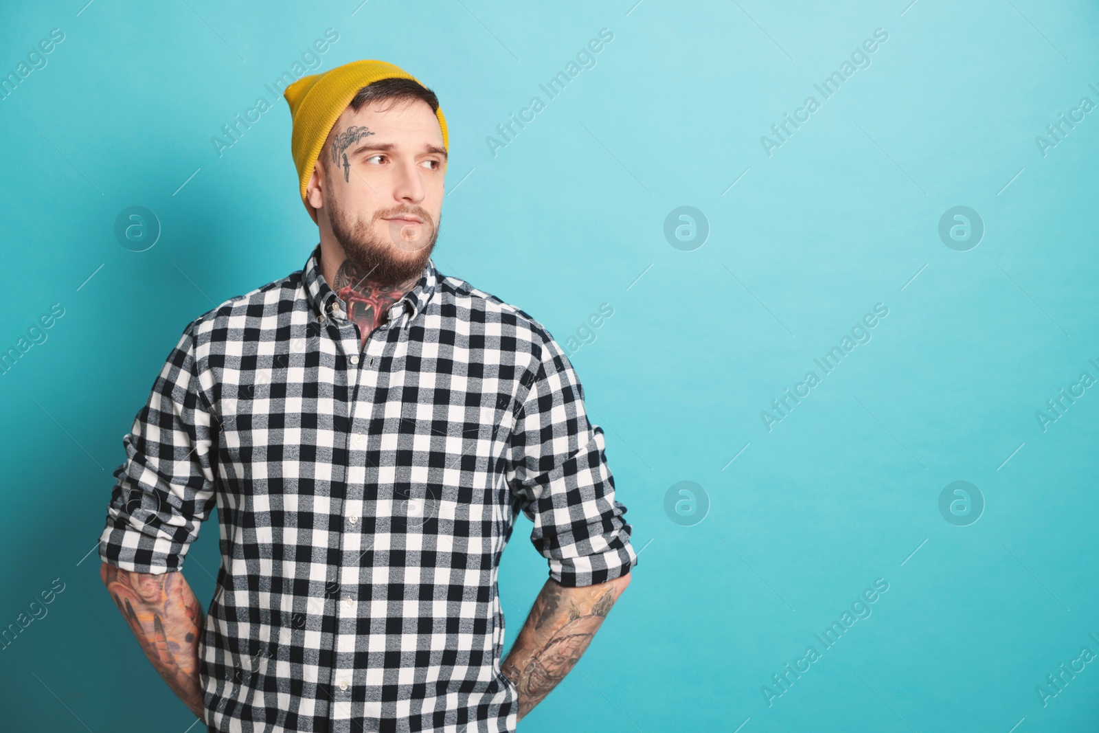 Photo of Handsome hipster man on light blue background. Space for text