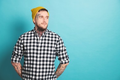 Photo of Handsome hipster man on light blue background. Space for text