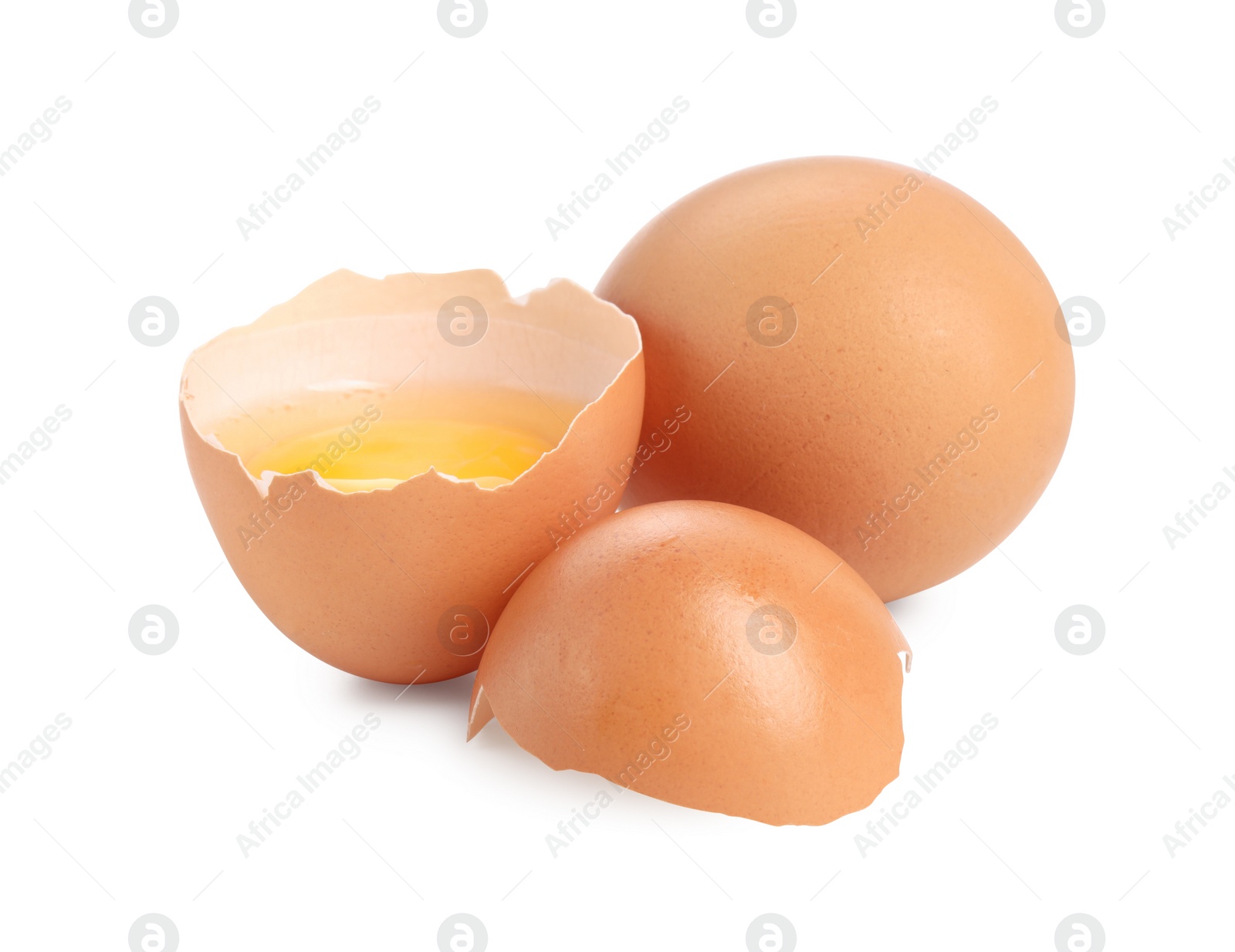 Photo of Whole and cracked chicken eggs isolated on white