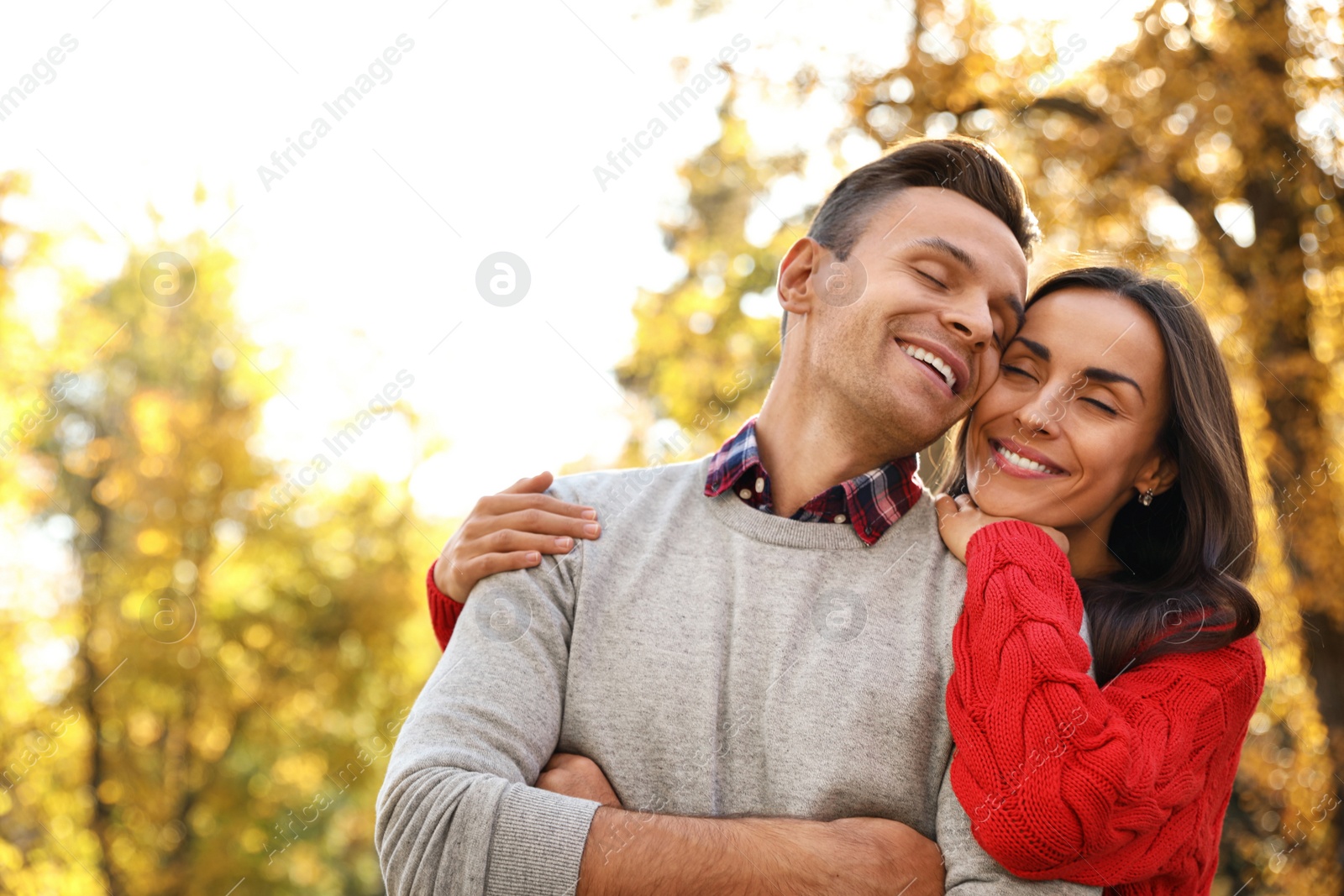 Photo of Happy couple in sunny park. Autumn walk