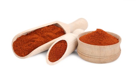 Photo of Scoops and bowl with aromatic paprika isolated on white