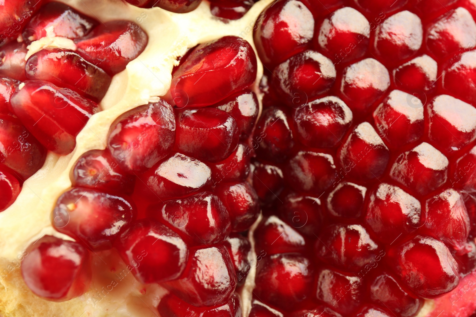 Photo of Ripe juicy pomegranate grains as background, closeup