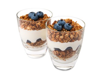 Photo of Glasses of tasty yogurt with muesli and blueberries isolated on white