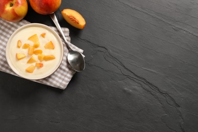Photo of Delicious yogurt with fresh peach on black table, flat lay. Space for text