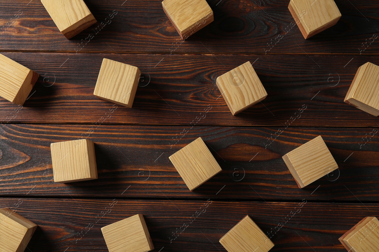 Photo of Blank cubes on wooden table, flat lay