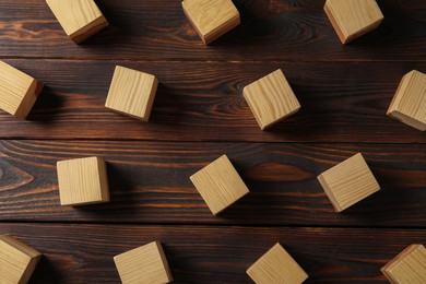 Blank cubes on wooden table, flat lay