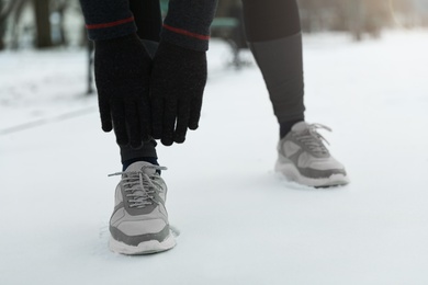 Photo of Man doing sports exercises in winter park, closeup