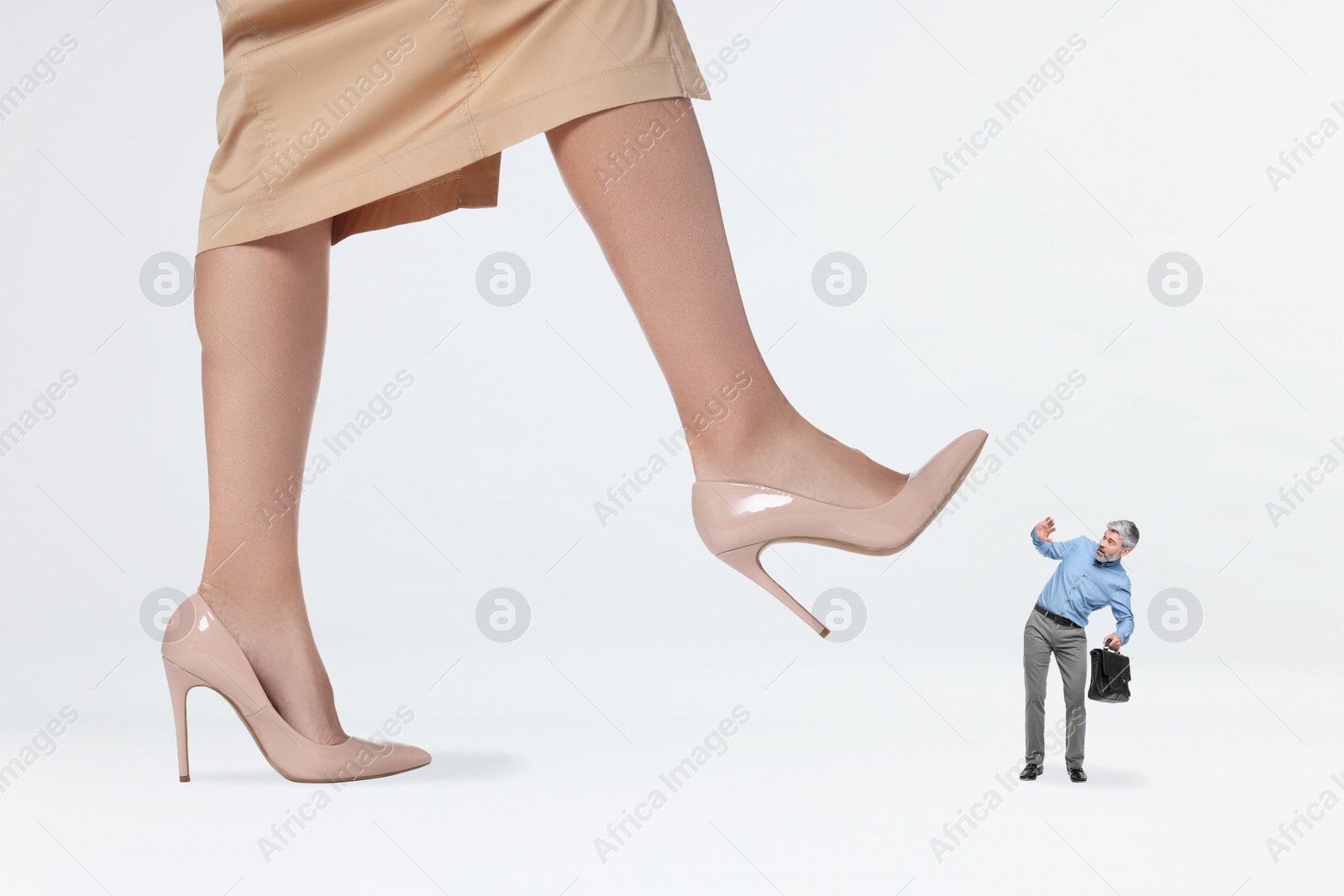 Image of Big woman stepping onto small man on white background