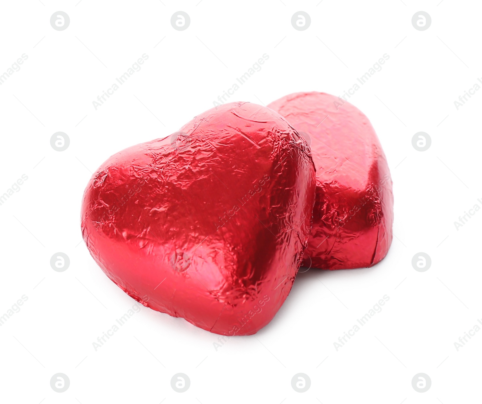 Photo of Heart shaped chocolate candies in red foil on white background