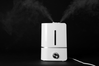 Photo of New modern air humidifier on black background
