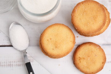 Photo of Tasty sweet sugar cookies on white wooden table, top view