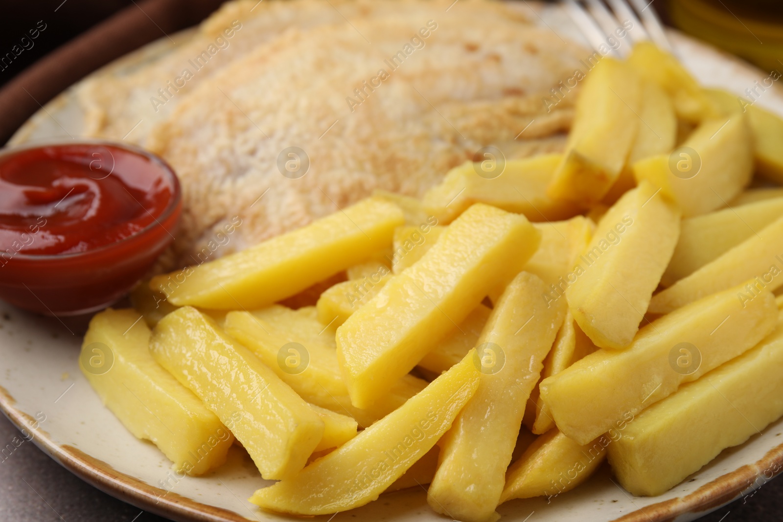 Photo of Delicious fish and chips with ketchup on plate, closeup