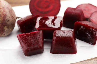 Frozen beetroot puree cube and fresh beetroot on white background, closeup
