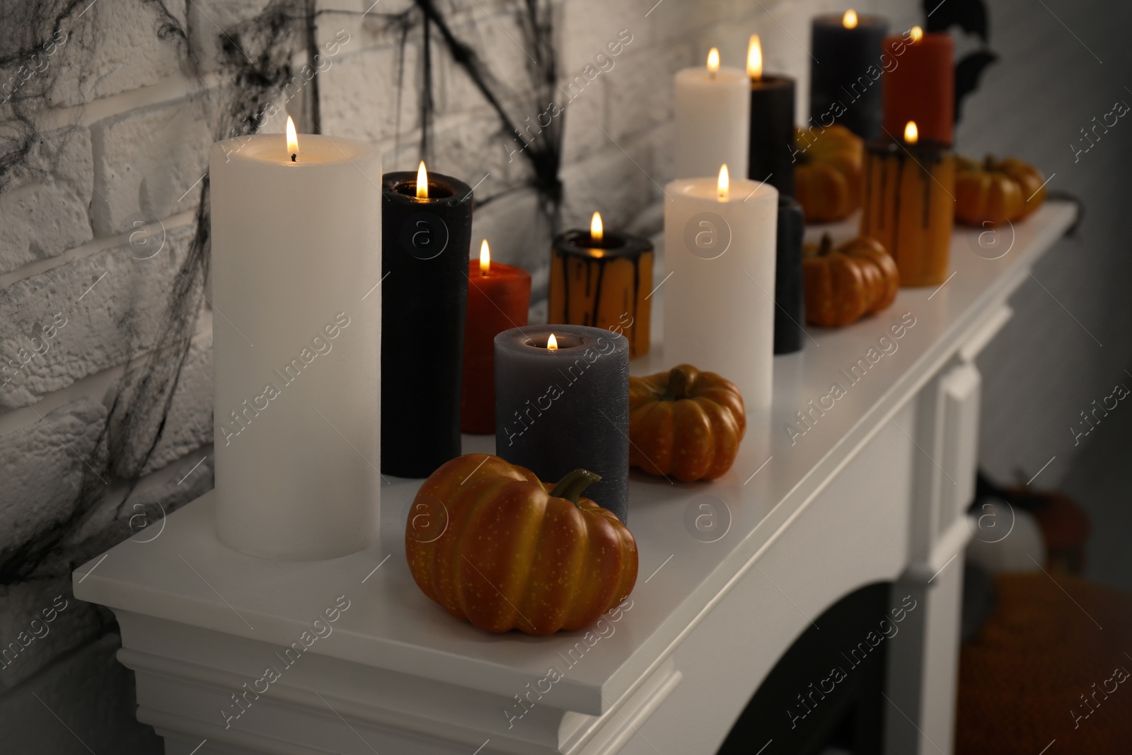 Photo of Fireplace with different Halloween decor indoors. Festive interior