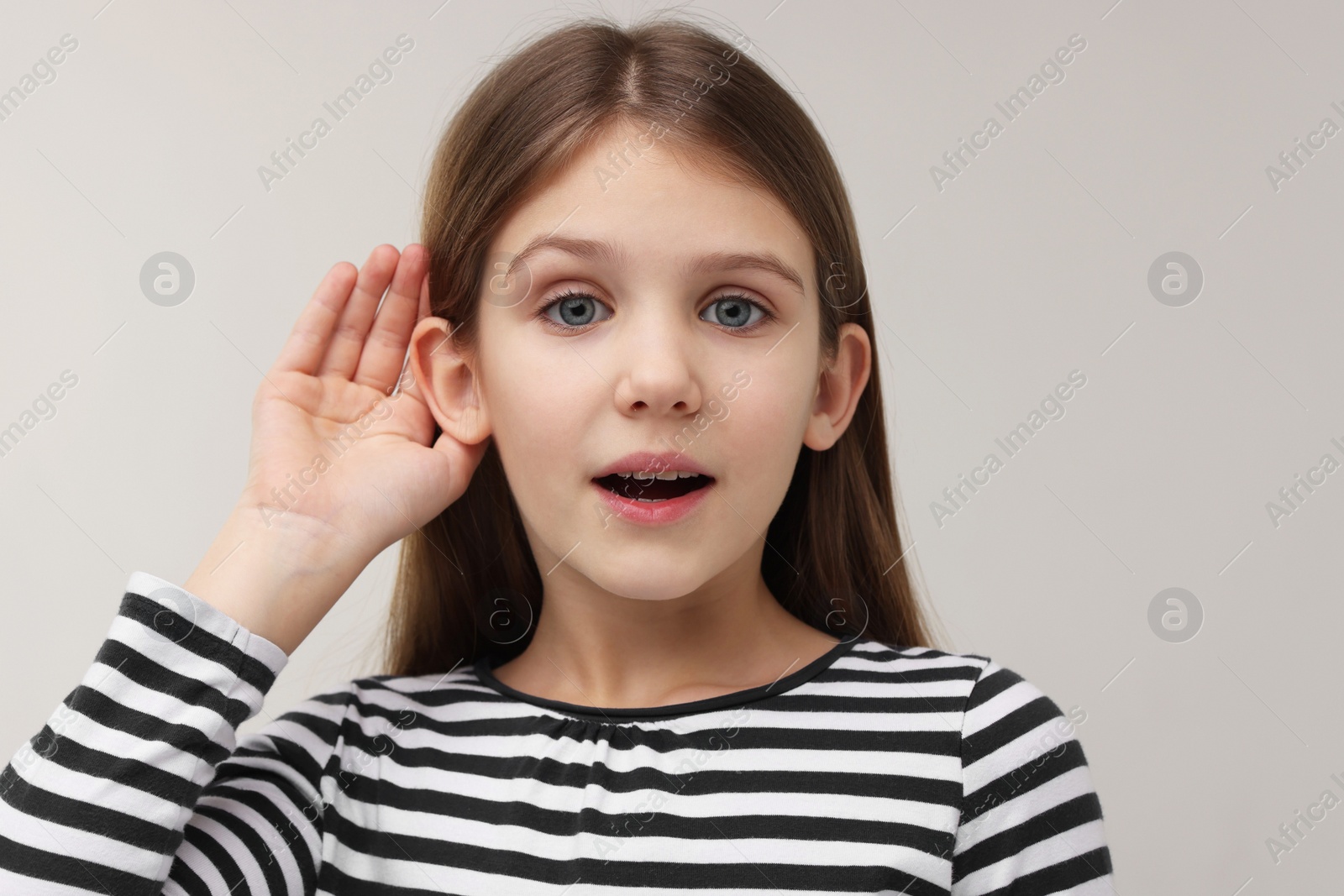 Photo of Little girl with hearing problem on grey background