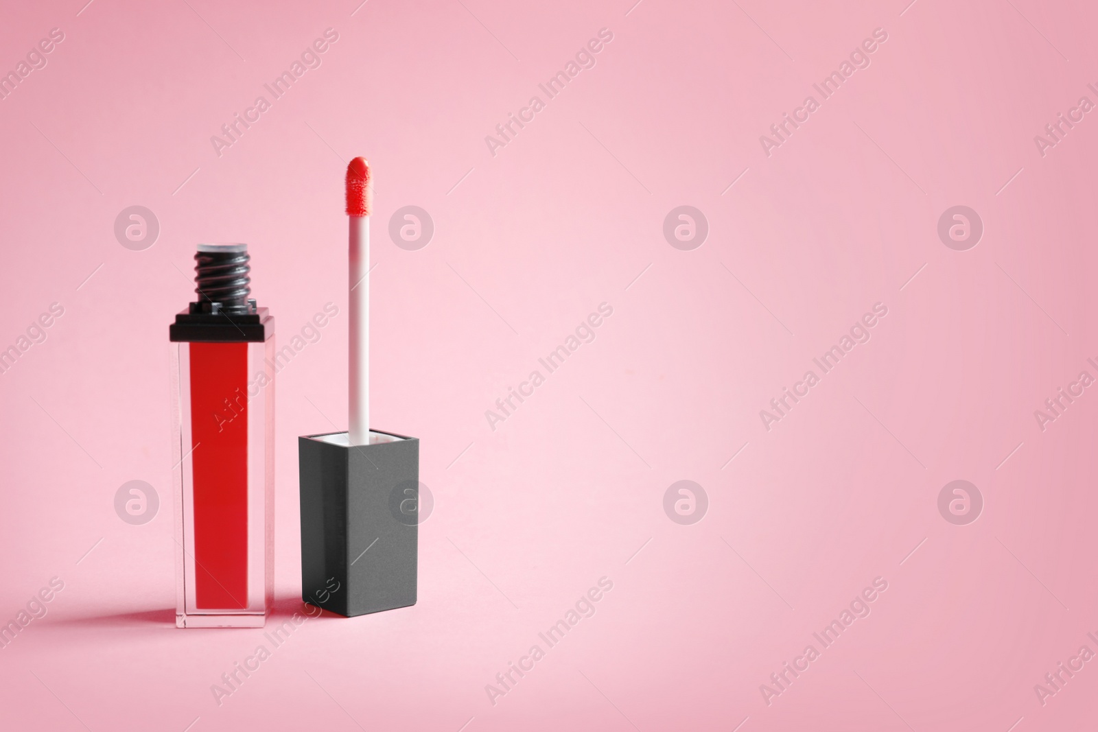 Photo of Applicator with liquid lipstick tube on color background. Space for text