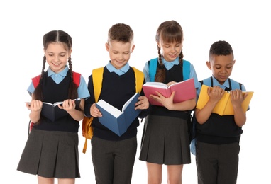 Portrait of cute children in school uniform with books on white background