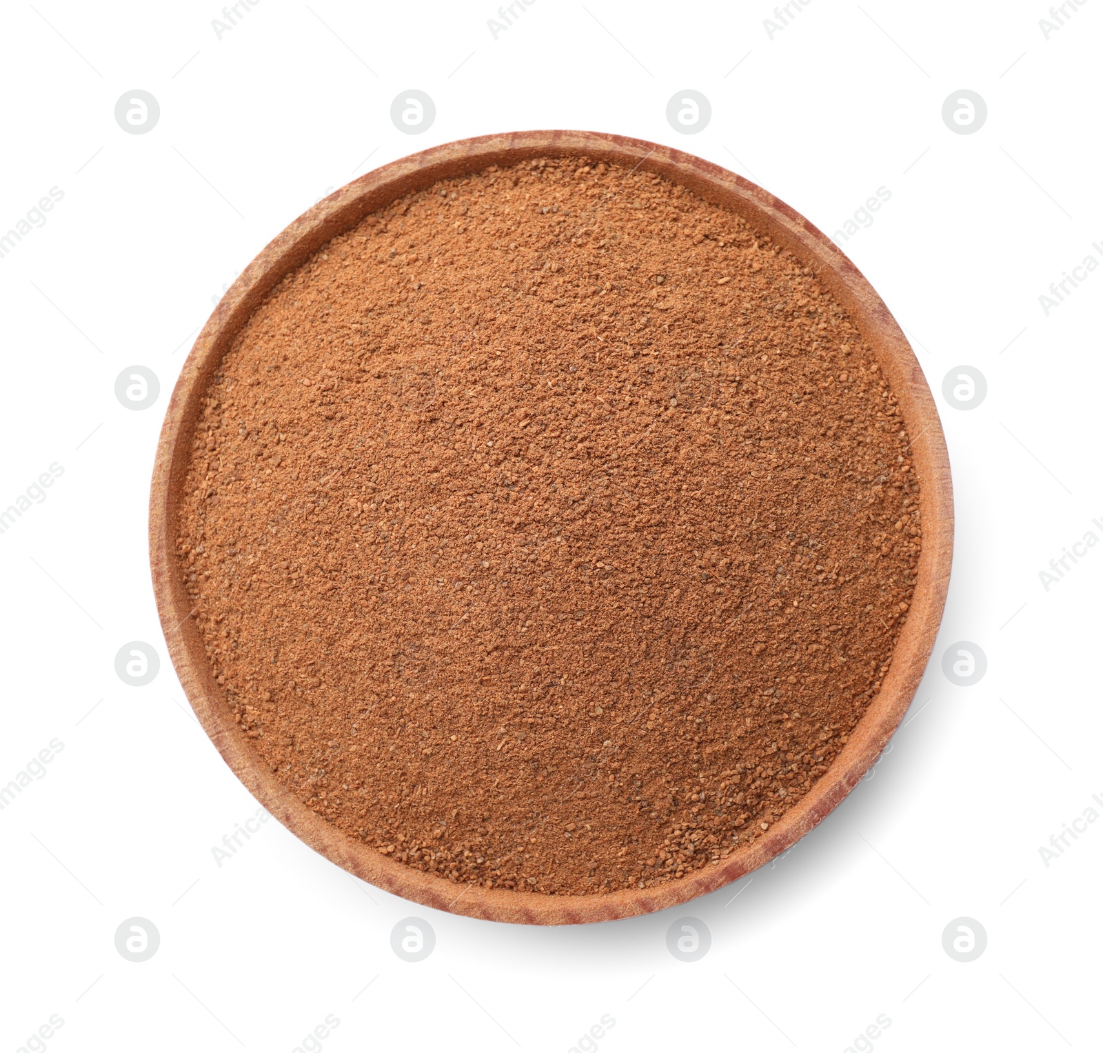 Photo of Wooden bowl with aromatic cinnamon powder isolated on white