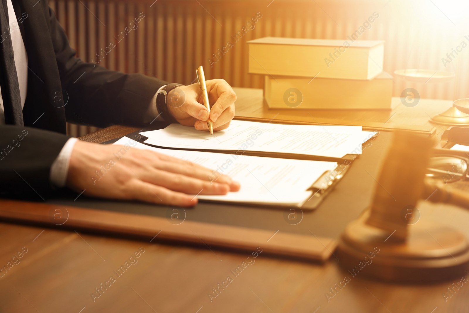 Image of Lawyer working with documents at wooden table in office, closeup