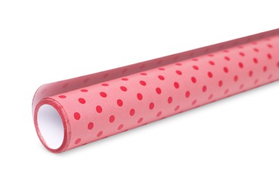 Roll of polka dot wrapping paper on white background