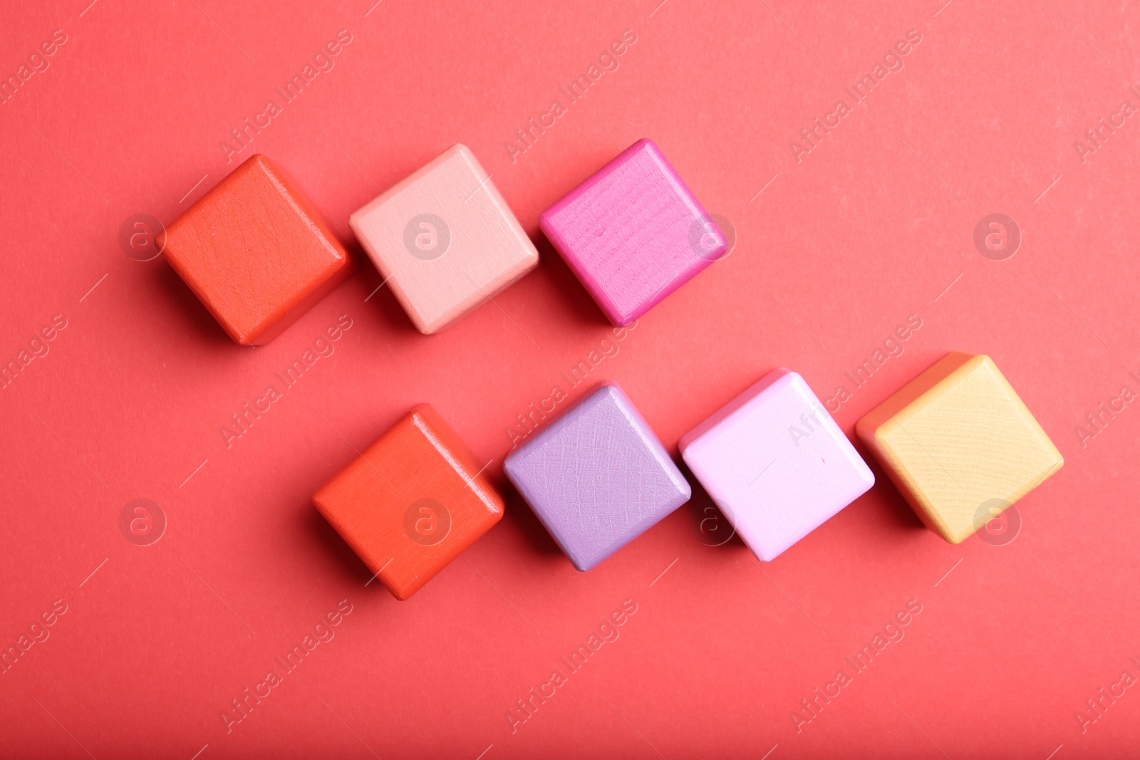 Photo of Colorful cubes with word KEYWORD on red background, flat lay