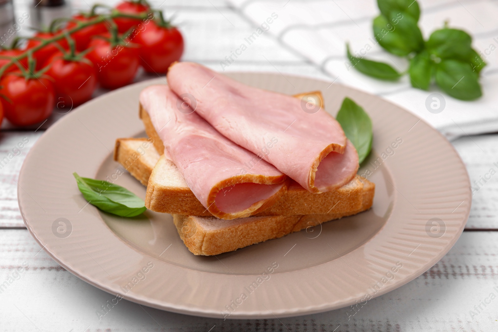 Photo of Delicious sandwich with ham on white wooden table, closeup