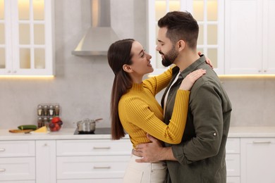 Happy lovely couple dancing together in kitchen