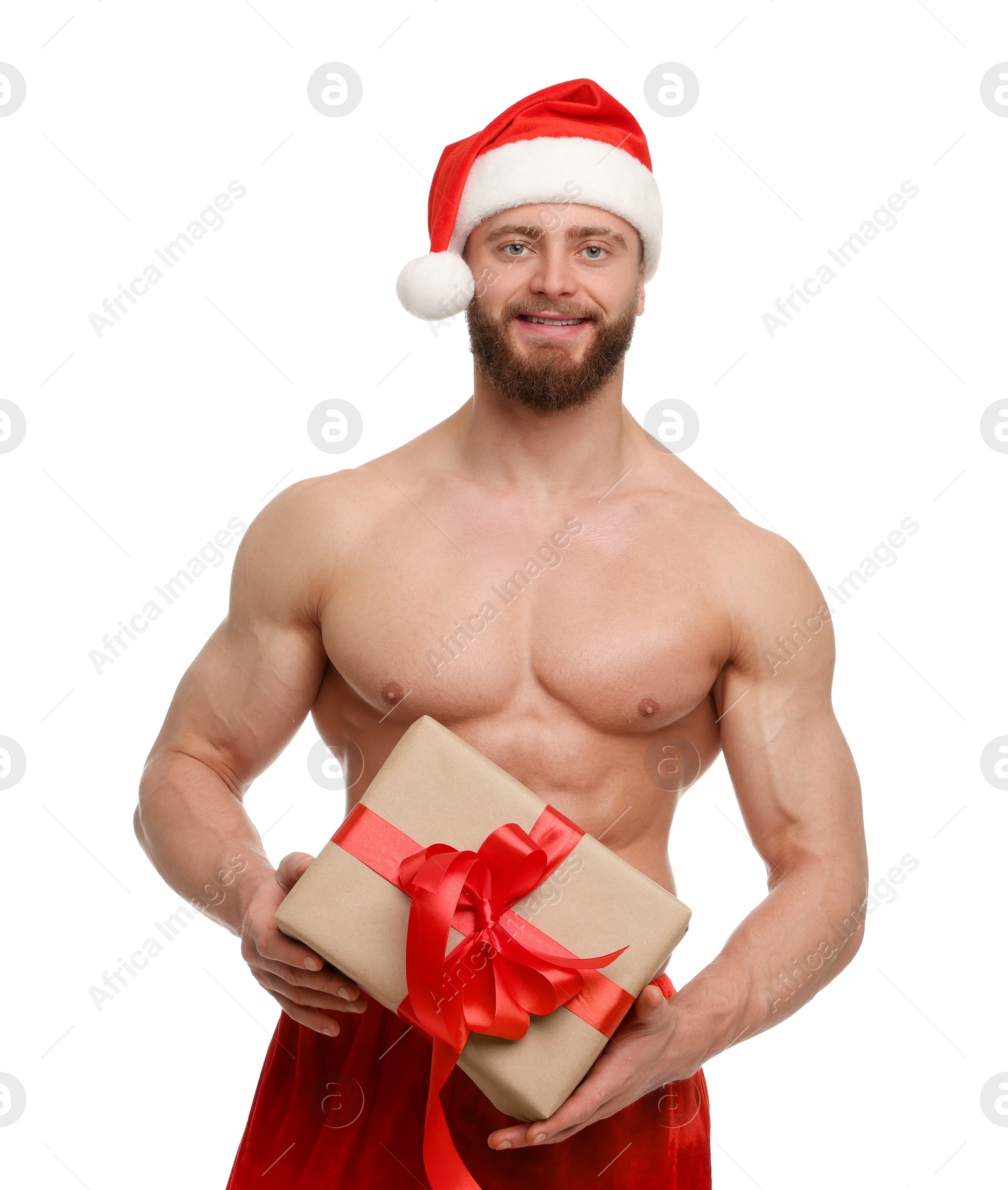 Photo of Attractive young man with muscular body in Santa hat holding Christmas gift box on white background