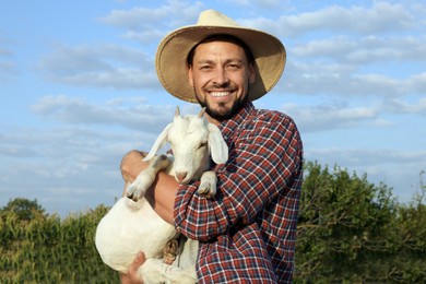Photo of Man with goat at farm. Animal husbandry