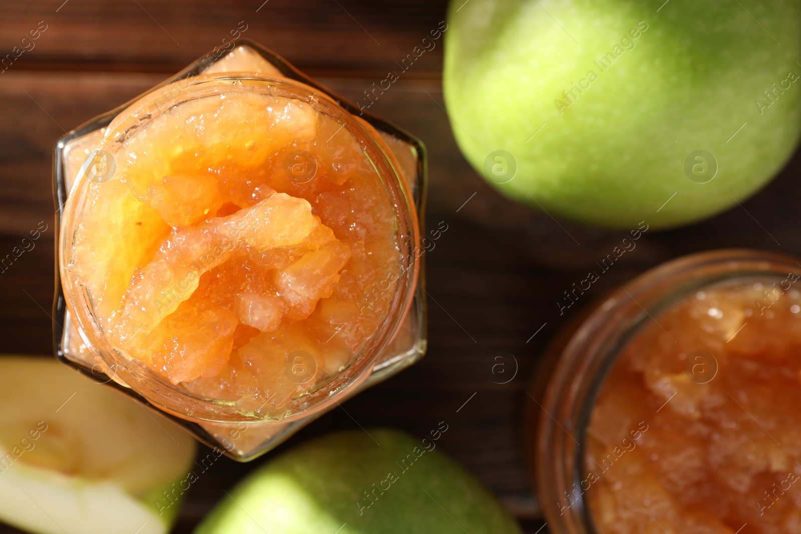 Photo of Delicious apple jam and fresh fruits on wooden, flat lay
