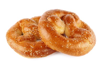 Tasty freshly baked pretzels on white background