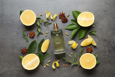 Photo of Flat lay composition with bottle of perfume and fresh citrus fruits on grey table