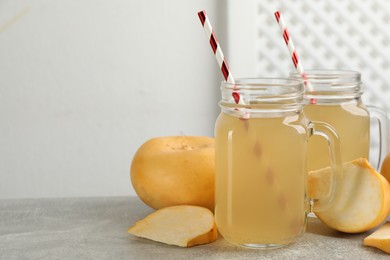 Photo of Freshly made turnip juice on light grey table, space for text