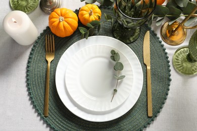 Beautiful autumn table setting. Plates, cutlery, glasses and floral decor, flat lay