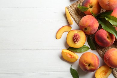 Photo of Fresh sweet peaches on white wooden table, flat lay. Space for text