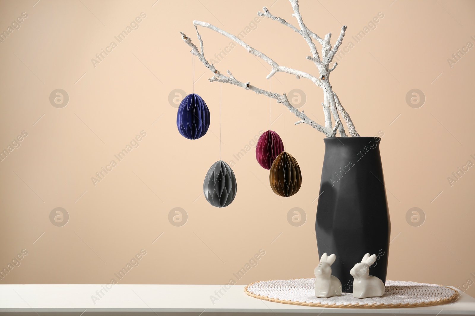 Photo of Beautiful festive composition with Easter decor on white table against beige background, space for text