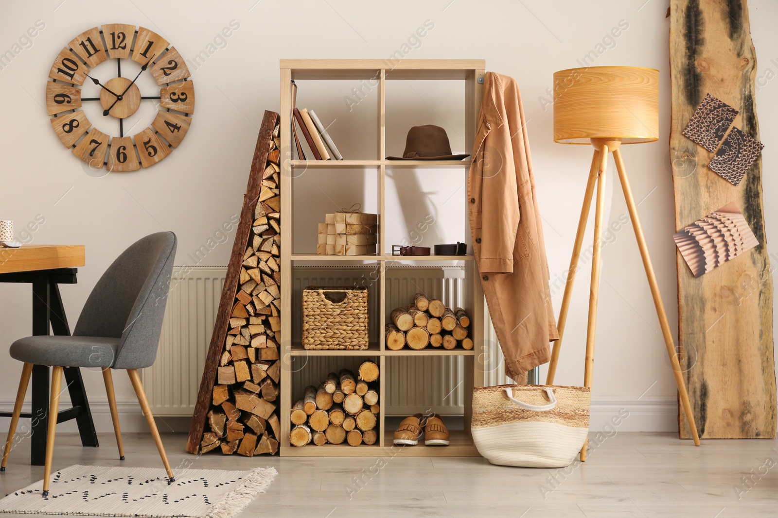 Photo of Stylish room interior with firewood as decorative element