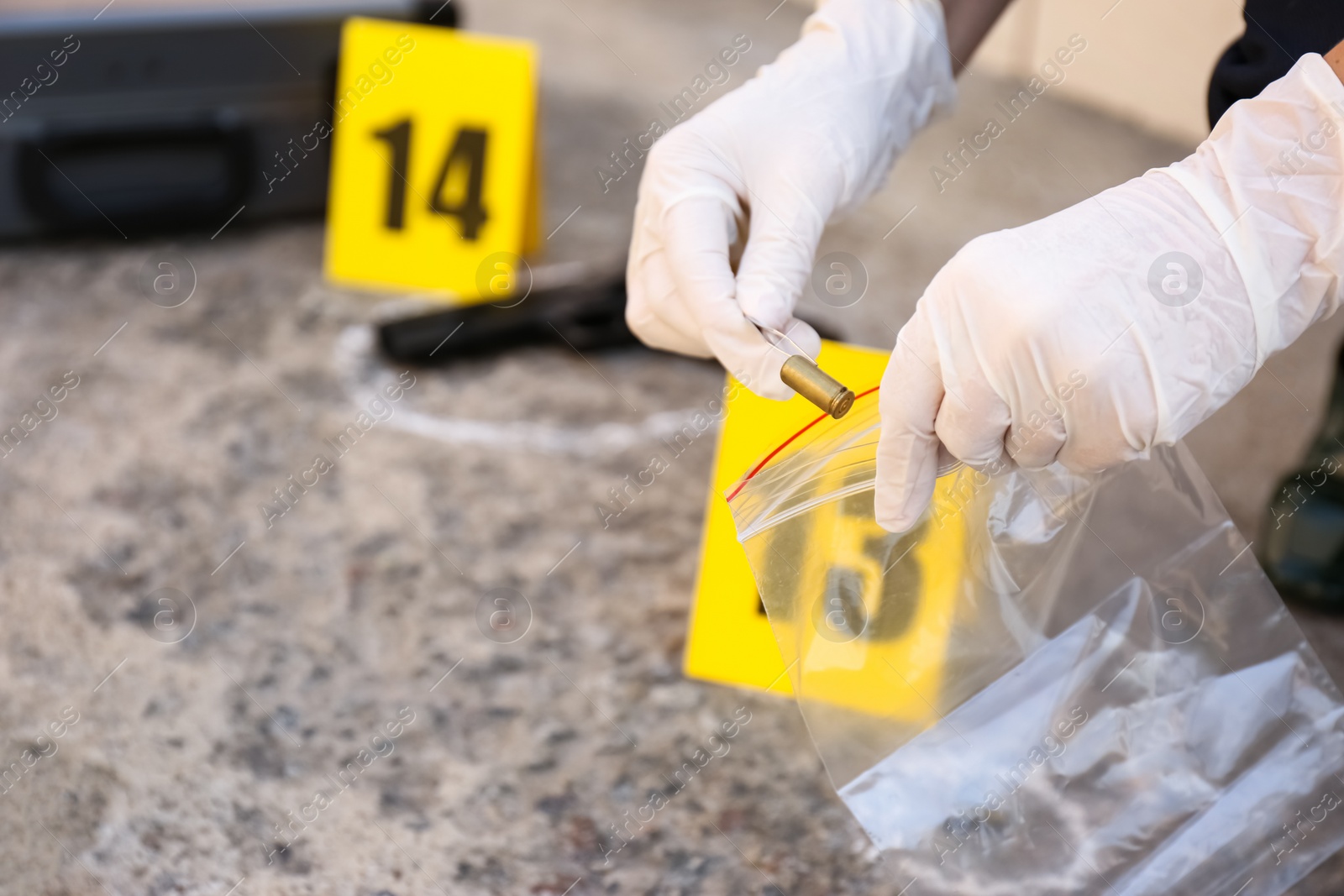 Photo of Detective collecting evidences at crime scene, closeup