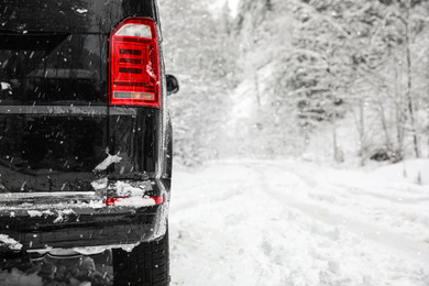 Photo of Closeup view of car on snowy country road