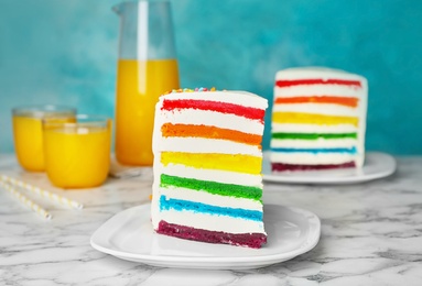 Photo of Delicious rainbow cake for party on table