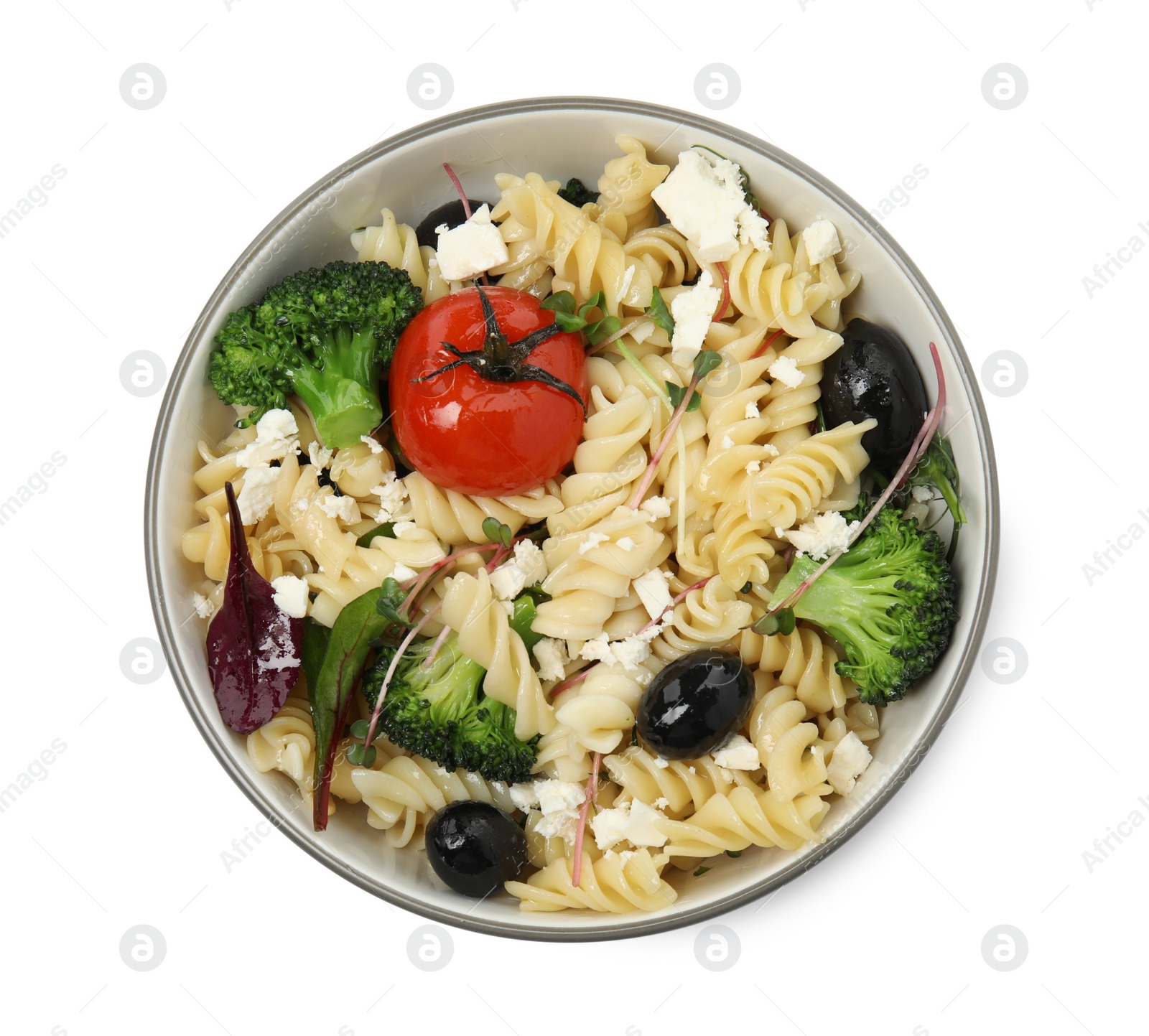 Photo of Bowl of delicious pasta with tomatoes, olives and broccoli on white background, top view