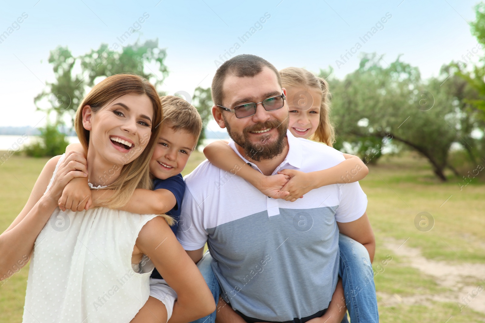 Photo of Happy family spending time together with their children outdoors